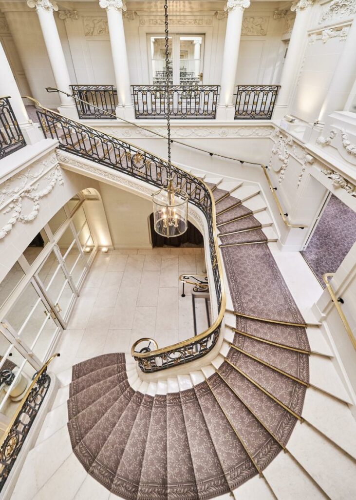 Le Pré Catelan welcomes guests with a grand hall and elegant staircase.
