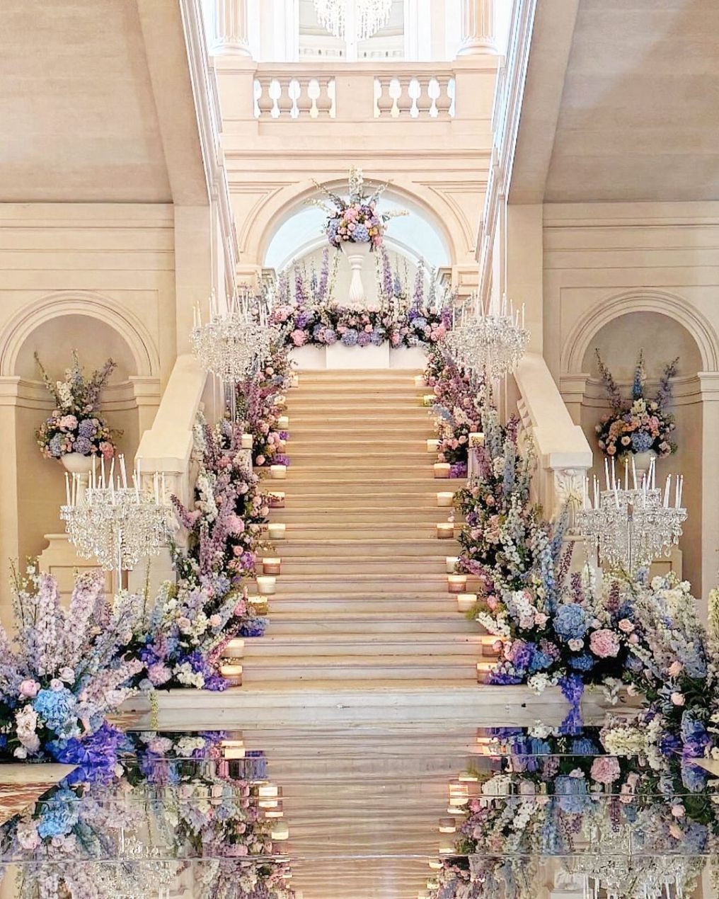 Floral arrangements on the staircase at Château de Saint-Martin-du-Tertre.